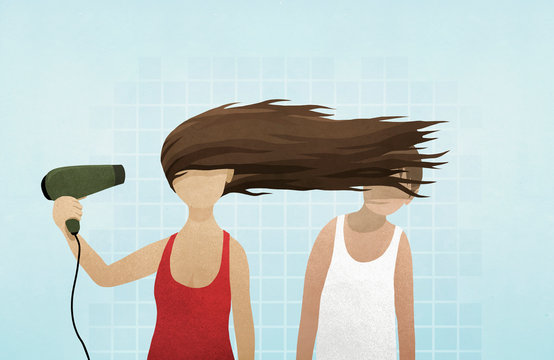 Woman blow drying hair in mans face