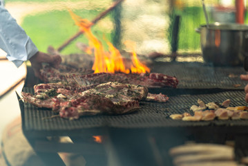 The meat on the grill. Cooking meat by Italian cooks. Meat festival in Tuscany. May 2019.