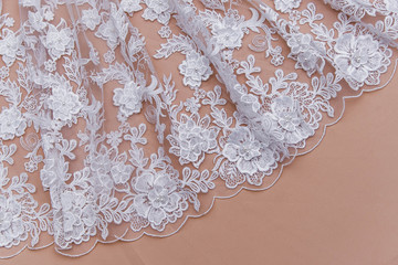 Obraz premium Texture lace fabric. lace on white background studio. thin fabric made of yarn or thread. a background image of ivory-colored lace cloth. White lace on beige background.