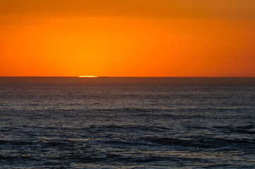 The sun sets over the horizon of the Atlantic Ocean