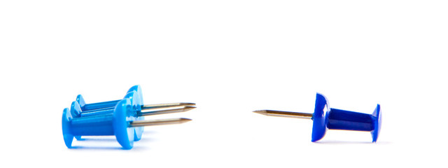 Business office stress problems and social pressure or peer pressure concept. Push pins of blue colors isolated on white background. Education concept.