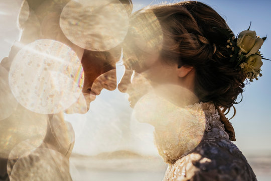 Golden light illuminating profile of bride and groom