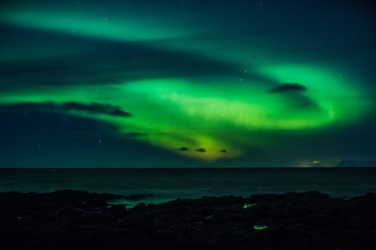 Mysterious Northern Lights over ocean, Reykjanesbaer, Iceland