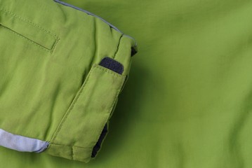 green fabric texture from the sleeve to the part of the jacket