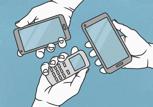 View from above hands holding cell phone and smart phones