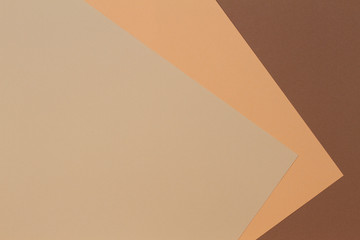 Color papers geometry composition banner background with beige, light brown and dark brown tones.