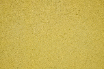 Yellow rough surface of the plastered wall