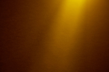 Small-textured background illuminated by a yellow ray of light