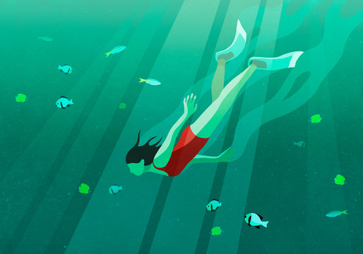 Woman swimming underwater in ocean surrounded by fish