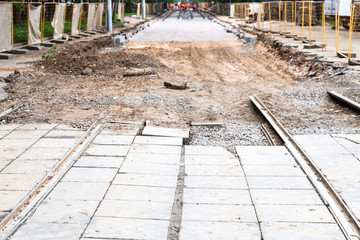 Fototapeta na wymiar disassembled tram road and laying of new rails