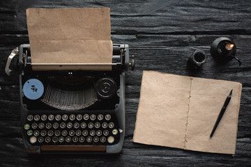 Blank page book with a copy space and old typewriter with letter on a black wooden table flat lay...