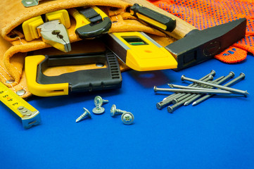 Professional tools for the joiner and spare parts on a blue background.