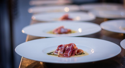 Chef finishing and garnishing food he prepared.