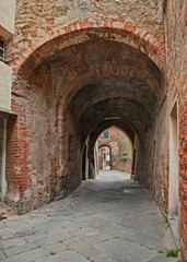 Fototapeta na wymiar Sinalunga, Siena, Tuscany, Italy: ancient alley in the old town