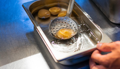 Chef finishing and garnishing food he prepared.