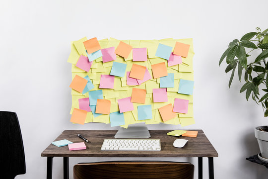 Adhesive notes covering computer in office