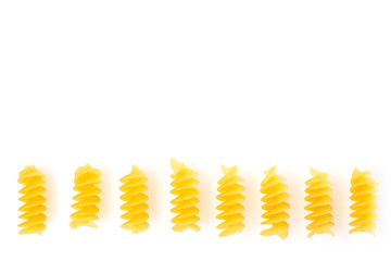 Dried corkscrew shaped pasta or fusilli pasta over white background