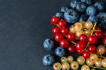 berries of red and white currants and blueberries in plastic packaging.