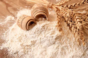 Flour in barrels on the table with years of Golden wheat on the table. Business concept of a rich harvest . Photo in grunge style. Agriculture.