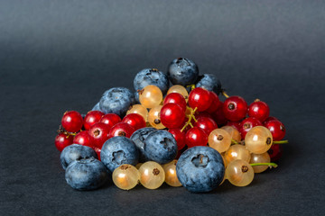 berries of red and white currants and blueberries in plastic packaging.
