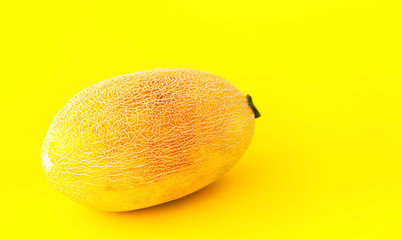 Whole fresh honeydew melon on yellow  background. Close-up