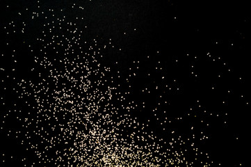 Obraz na płótnie Canvas Black background with golden sparkles. Blurred effect