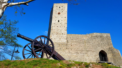 A cannon defending an old stone castle in Poland.