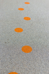 Orange circles on asphalt. Concept of road, way, idea, life. Circle pattern.