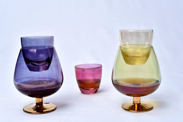 Colorful drinks glass cup on table on white background