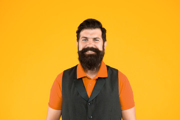 Restaurant cafe staff wanted. Man bearded hipster with mustache wear vest and shirt uniform yellow background. Shop staff concept. Salesman cashier career. Hiring shop store worker. Hospitality staff
