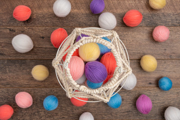 White knit basket with pastel color wool balls