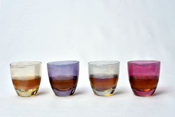 Colorful drinks glass cup on table on white background