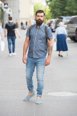 Mature hipster with beard. Bearded man. Confident brutal man walk street. Male hair barber care. brutal hipster with hiking backpack. adventure concept. urban style. Adventure awaits, go find it