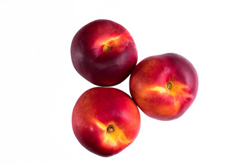 Fototapeta na wymiar three peaches nectarine on a white background