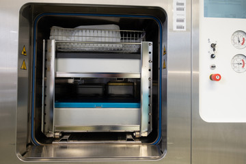 Fototapeta premium different instrument containers are pushed into a sterilization unit