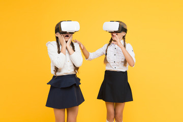 VR headset. Future education. Children schoolgirls wear wireless VR glasses. Exploring augmented...