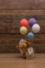 Baby sheep plushie and yarn balls on sticks