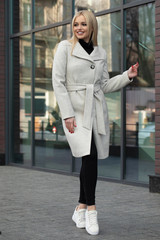 Beautiful girl in a coat walking in the city