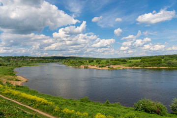 Fototapeta na wymiar Stunning view from the hill on the Oka River and beautiful clouds in the blue sky