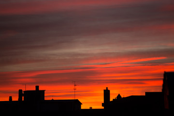 Silhouette of houses on a background of red-pink sunset.Copy space 