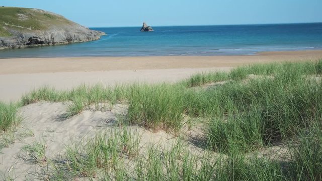 Looking out across sand dunes at Broad Haven South beach