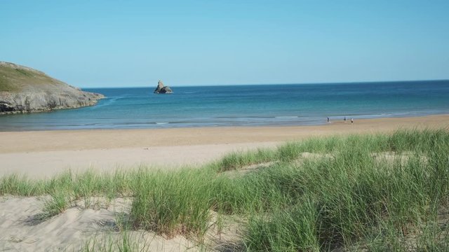Looking out across sand dunes at Broad Haven South beach