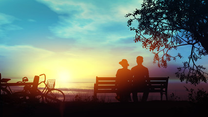 Couple on a bench watching the ocean after a bike ride