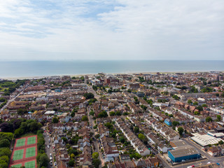 Fototapeta na wymiar Aerial photo of the town of Worthing, large seaside town in England, and district with borough status in West Sussex, England UK, showing typical housing estates and businesses on a bright sunny day