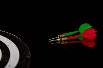 Colored arrows on a black background and target. Hit the target