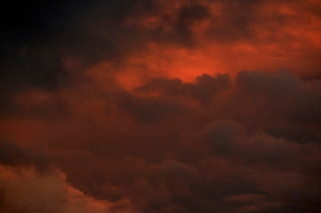 Intense orange sunset sky over Florida filled with thick storm clouds.