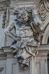 Statue of powerful and emotional atlas of Renaissance Era as support for building facade in Vienna, Austria, details, closeup