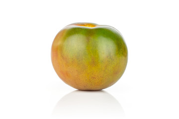 One whole fresh greenish red tomato isolated on white background