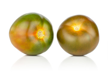 Group of two whole fresh greenish red tomato isolated on white background
