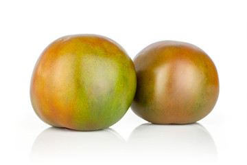 Group of two whole shiny fresh greenish red tomato isolated on white background